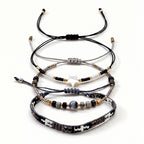 Black, White and Gold-Tone braided three-piece bracelet set with adjustable pull cords | BRA509-01 | image 1