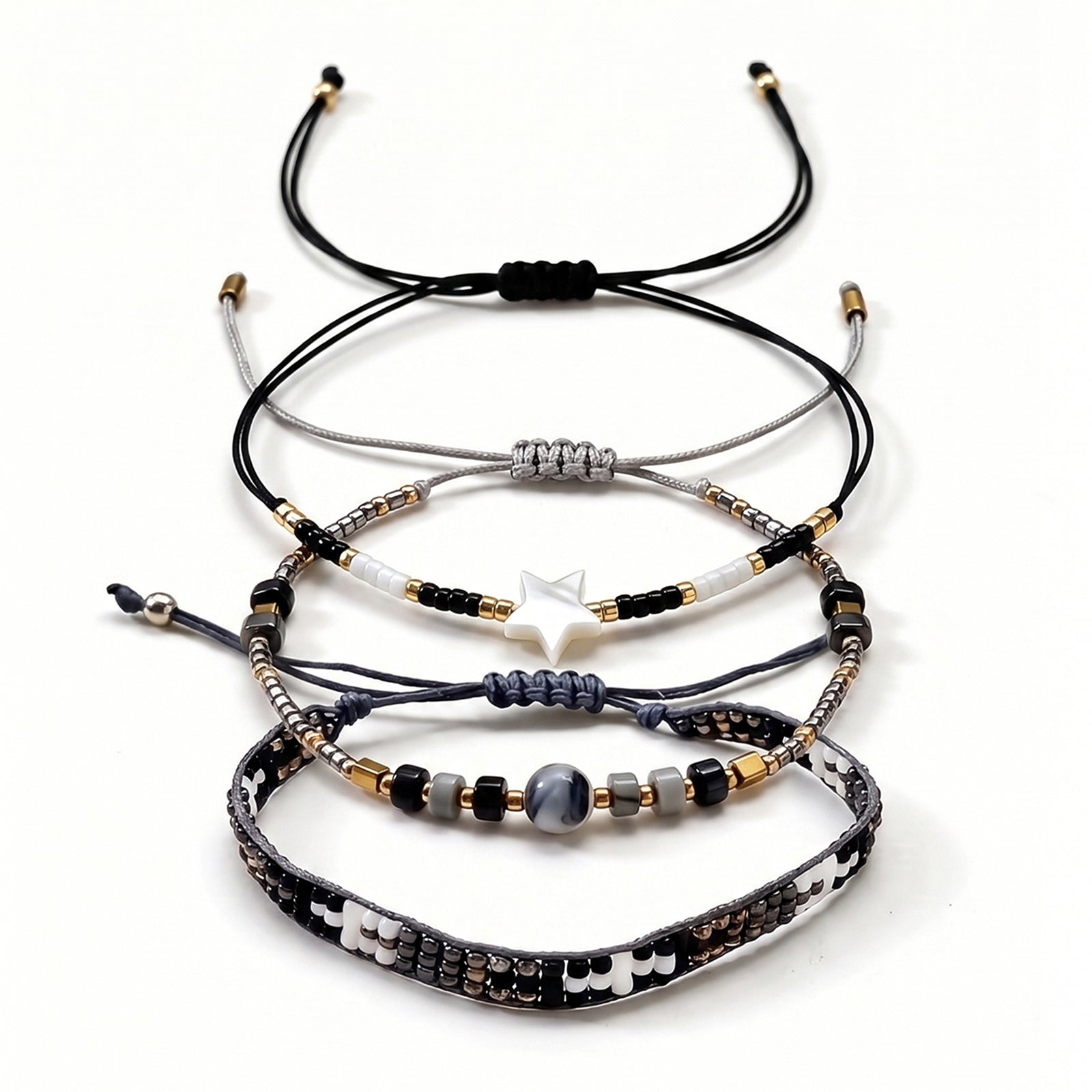 Black, White and Gold-Tone braided three-piece bracelet set with adjustable pull cords | BRA509-01 | image 1