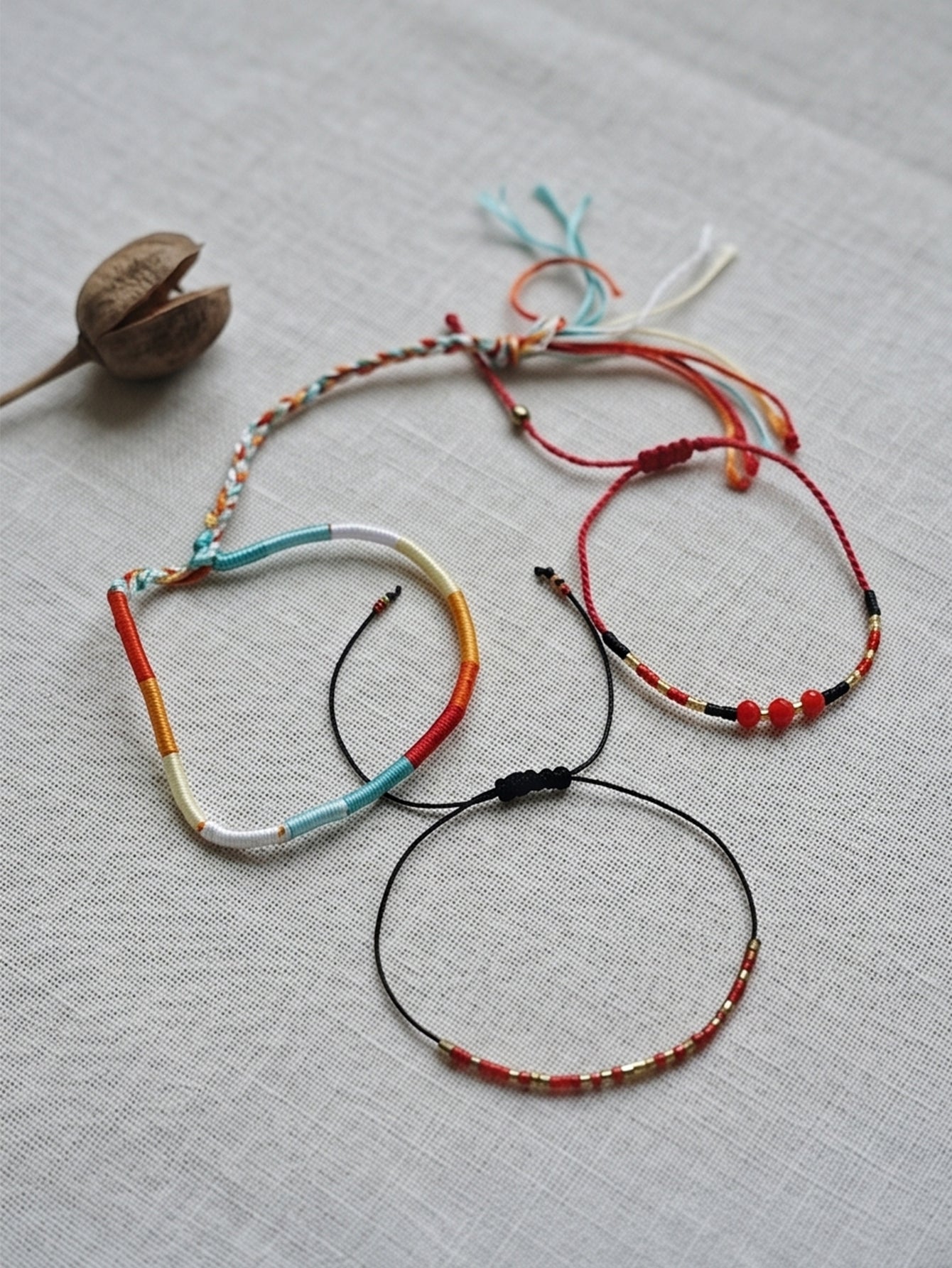Red braided three-piece bracelet set with adjustable pull cords | BRA575-01 | image 4