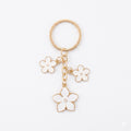 White cherry blossom keychain with floral accents