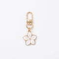 White cherry blossom keychain with floral accents