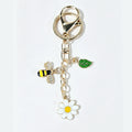 Gold-tone bee daisy leaf keychain accessory